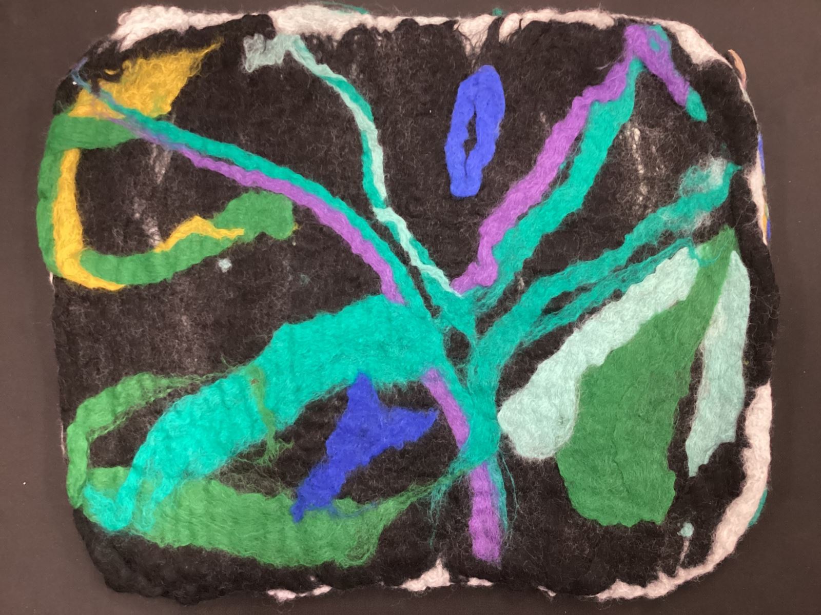 multicoloured plant on a black background