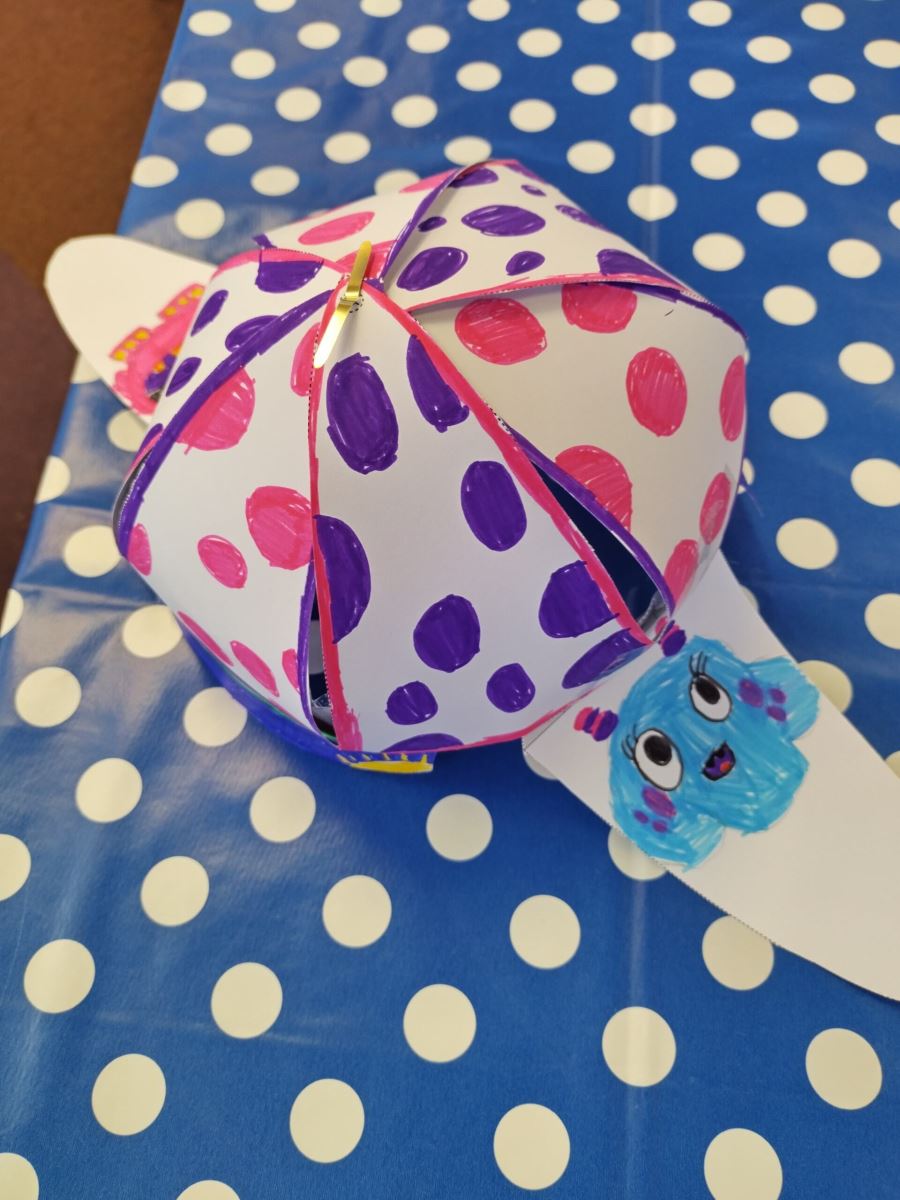 a purple and pink polka dotted deerstalker hat