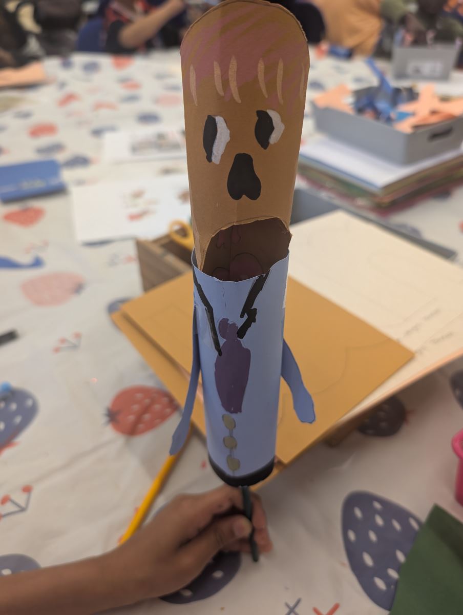 A tube painted to look like a person in a blue suit