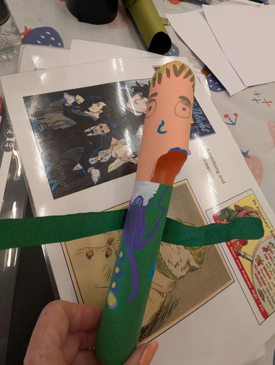 A tube painted to look like a person in a green suit